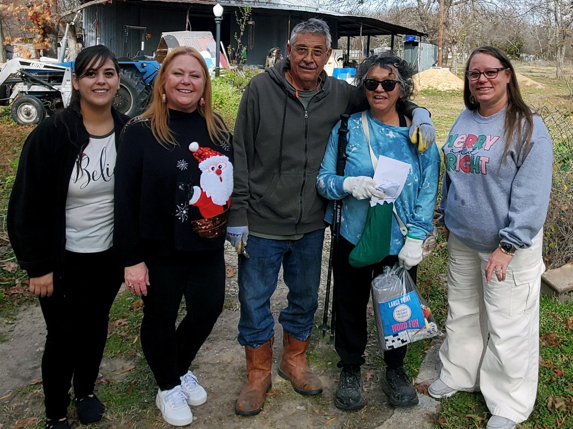 City Employees deliver Stockings for Seniors and pose with a recipient