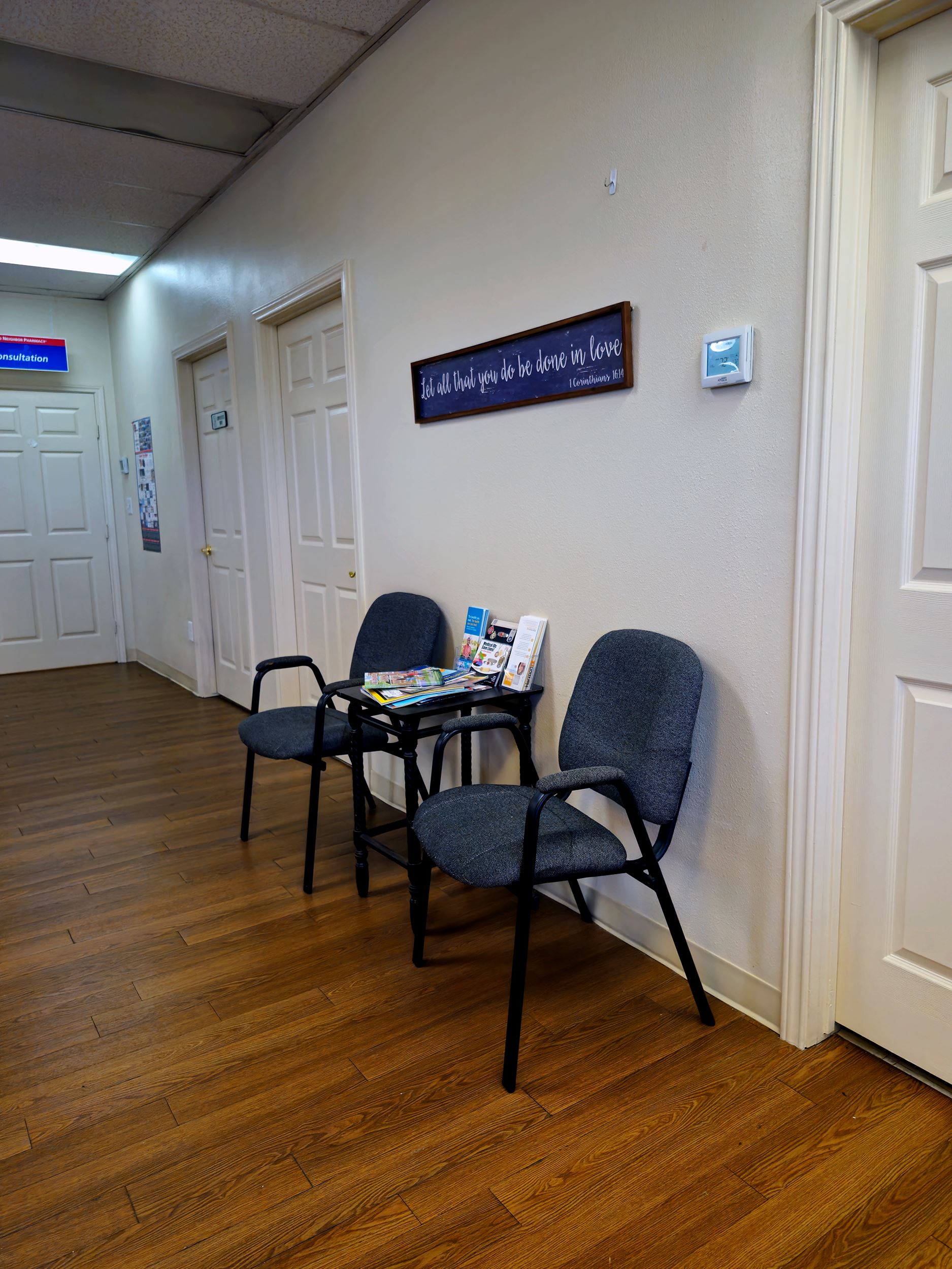 Two chairs between two doors for waiting room