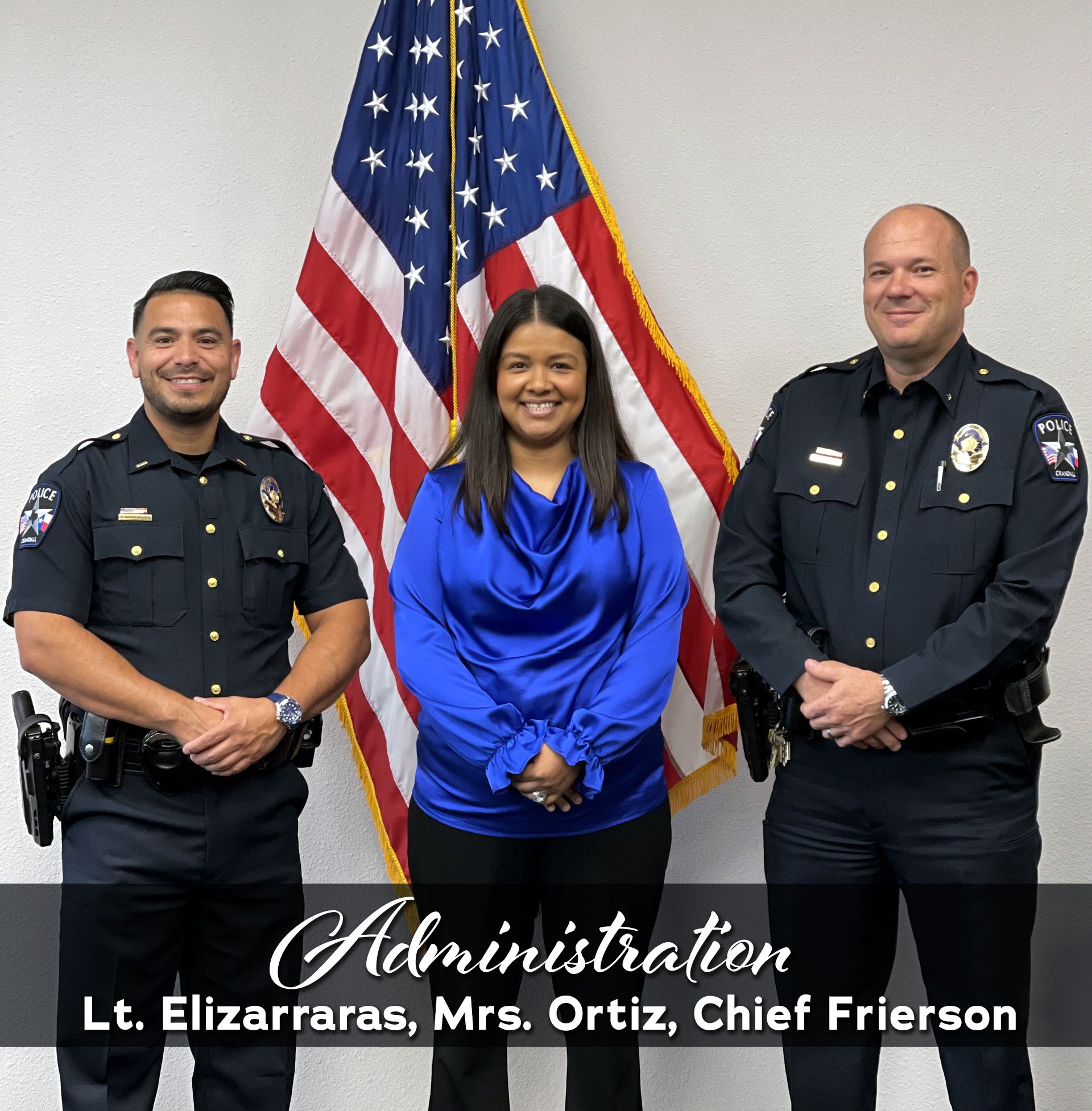 Administrative staff standing in front of American flag
