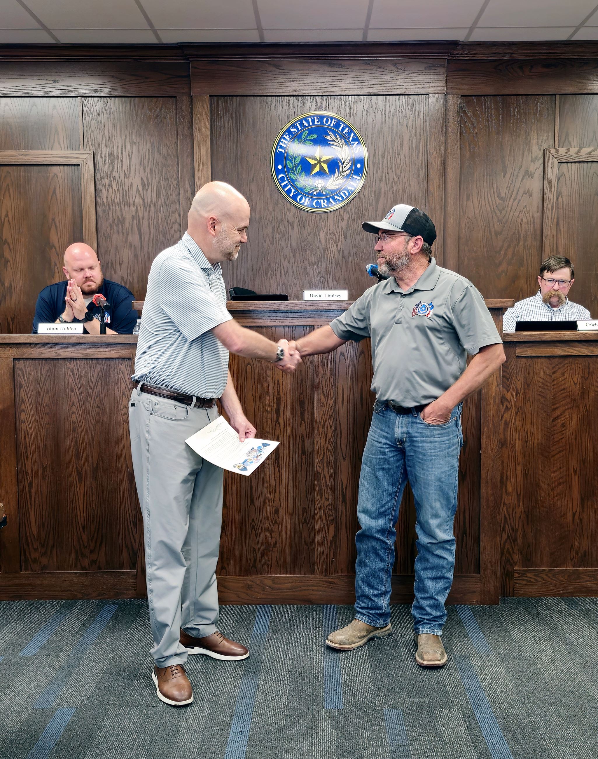 Mayor Lindsey shakes hands with Public Works Director Brad Piland, proclaiming Public Works Week
